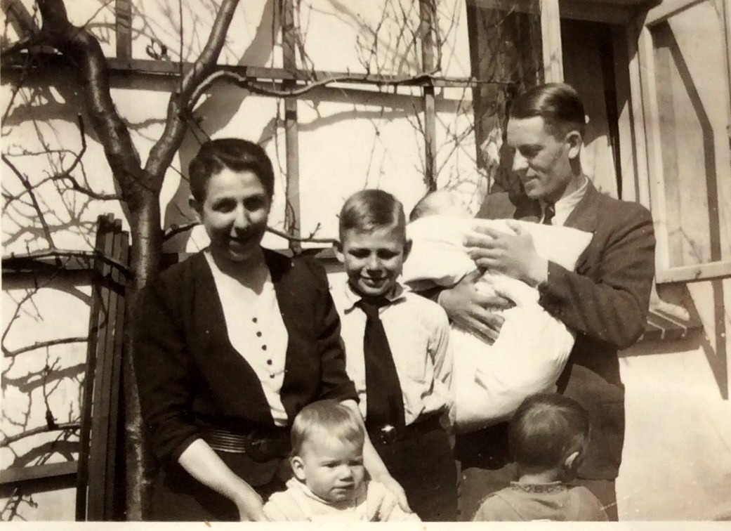 MY DAD HOLDING ME, 2 MONTHS OLD, OUTSIDE THE HOUSE WHERE I WAS BORN IN, WITH FRIENDS, OLDENBURG, GERMANY 