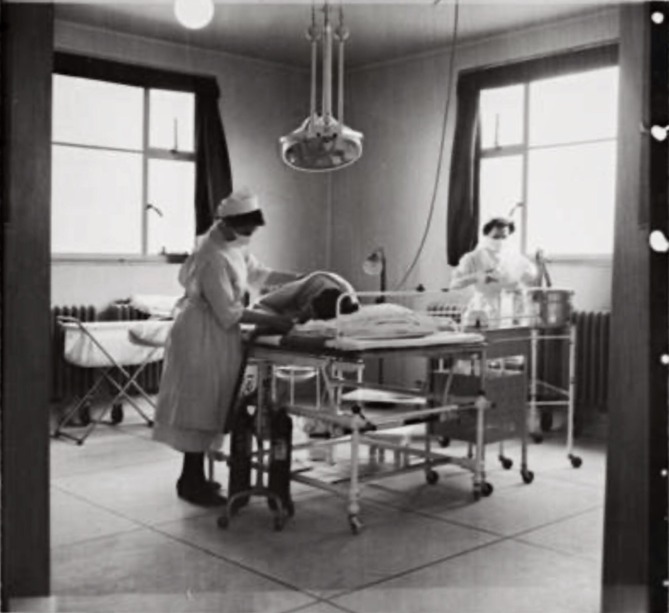 Nurses attending a woman in labour in the labour theatre at the Maternity Hospital in Great Wester Road 26th May 1943.