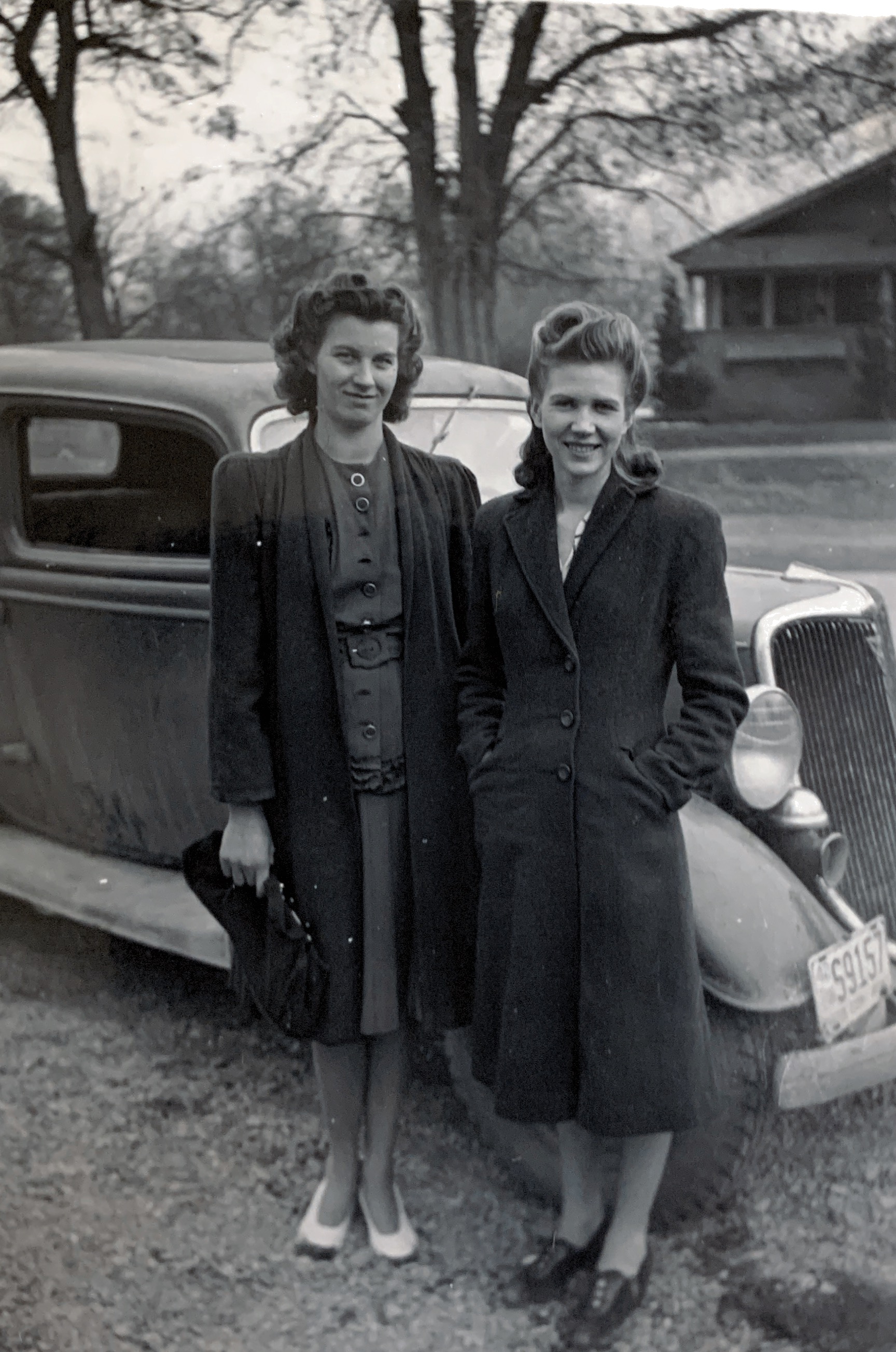 Leora with girlfriend Dorothy Moore.  Info from Corey: Sent this to the car guru on Twitter to see what kind of car it was. Looks like it's the same car as Bonnie and Clyde's death car.  .------‐--‐---------- A couple more stylish cuties with a Ford, this one a 1934 Model 40 Tudor. The gals' fashions and hair suggest the photo was circa 1940 or so.