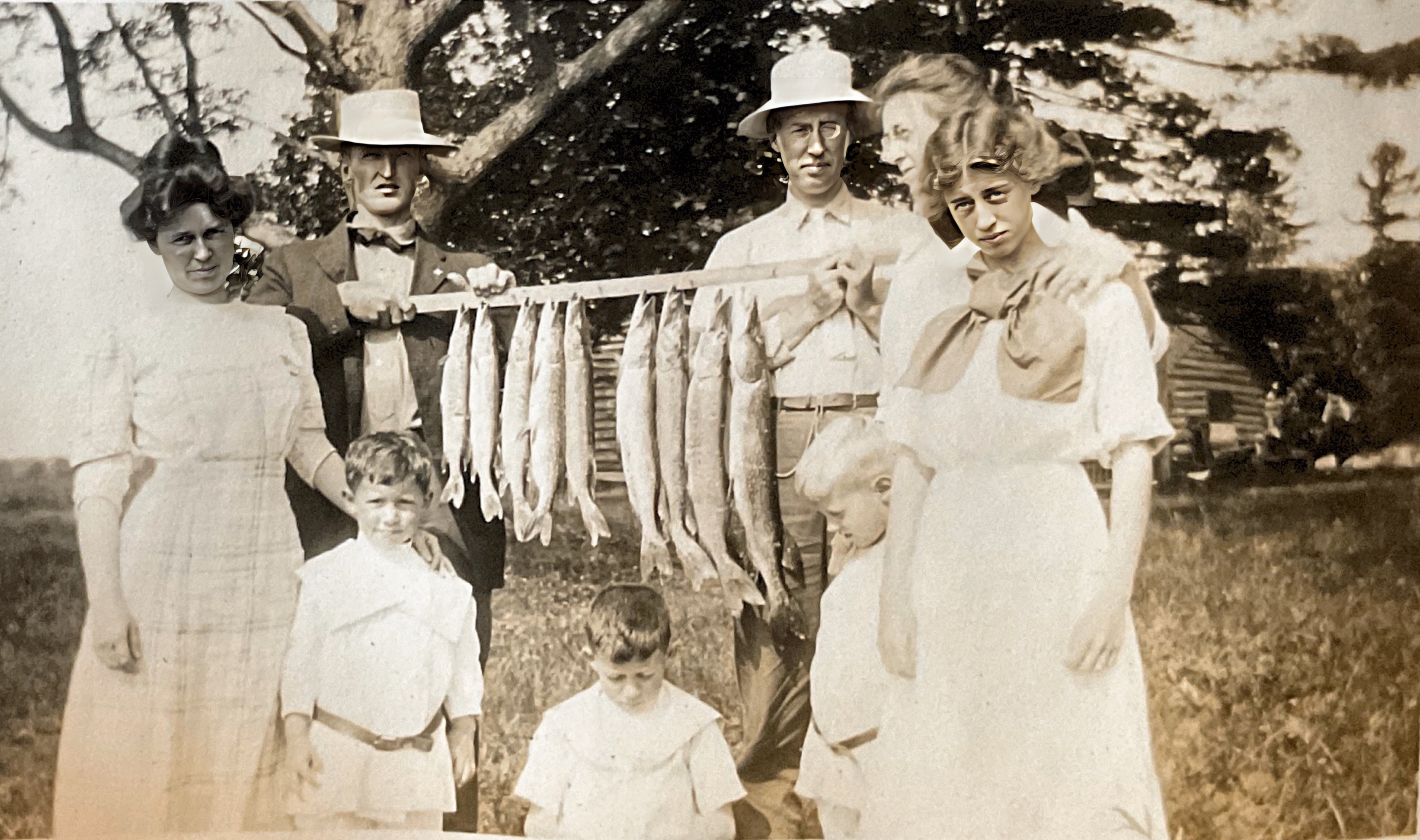 Bert Lauren with fish on right, Mary Lauren looking bored, and Charles Lauren behind her, July 1912.