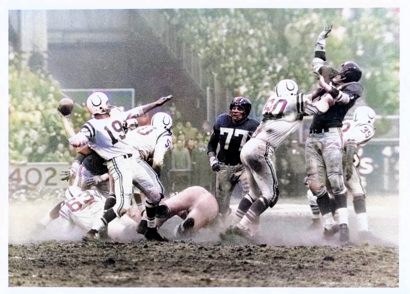 1958 NFL Championship Game between Baltimore Colts and NY Giants . Johnny Unitas throwing a long pass. Photo from the Baltimore Sun News wire many years ago..Colorized by me in 2022.