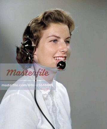 1960 beautiful woman wearing headphones mic on chin