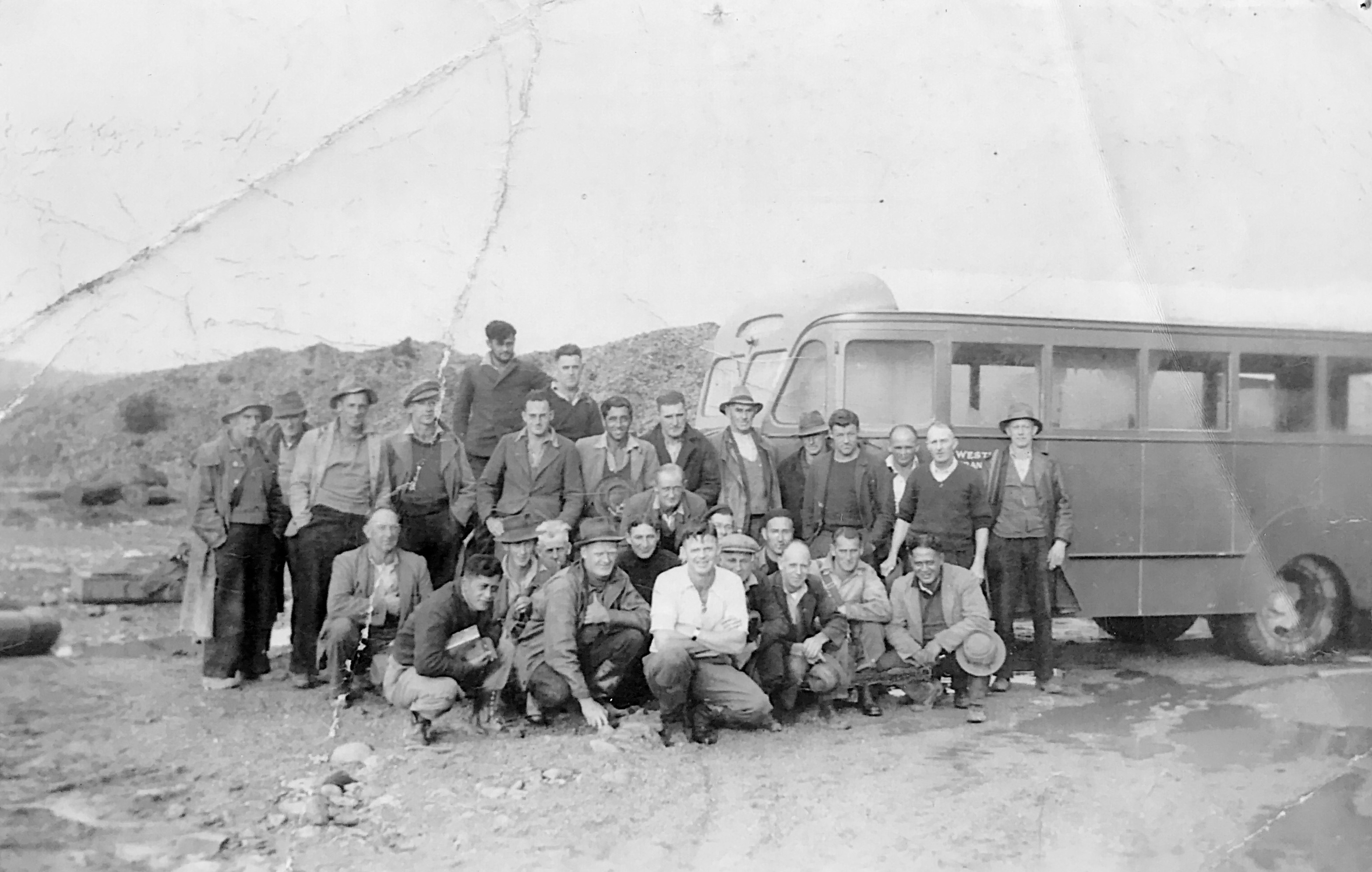 Arahura Dredge workers posing beside dredge bus. Late 1950s?